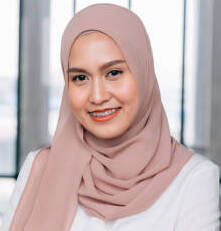 istockphoto-1199571022-612x612 (1) Young happy and successful South East Asian Islamic business woman with arms crossed in business corporate building setting looks at camera. She wears head scarf or hijab and modern elegant clothes